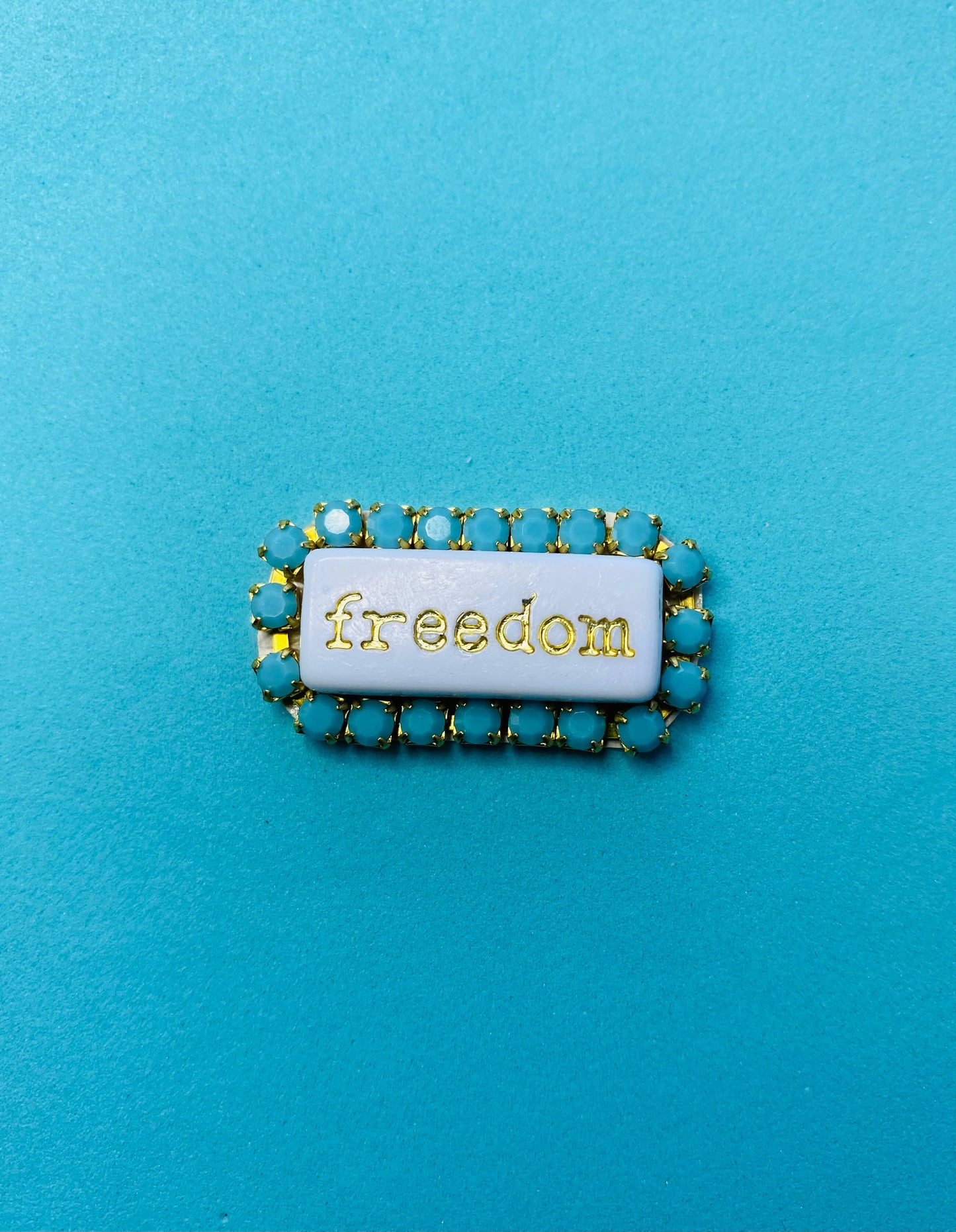 “WORD” rhinestone brooch